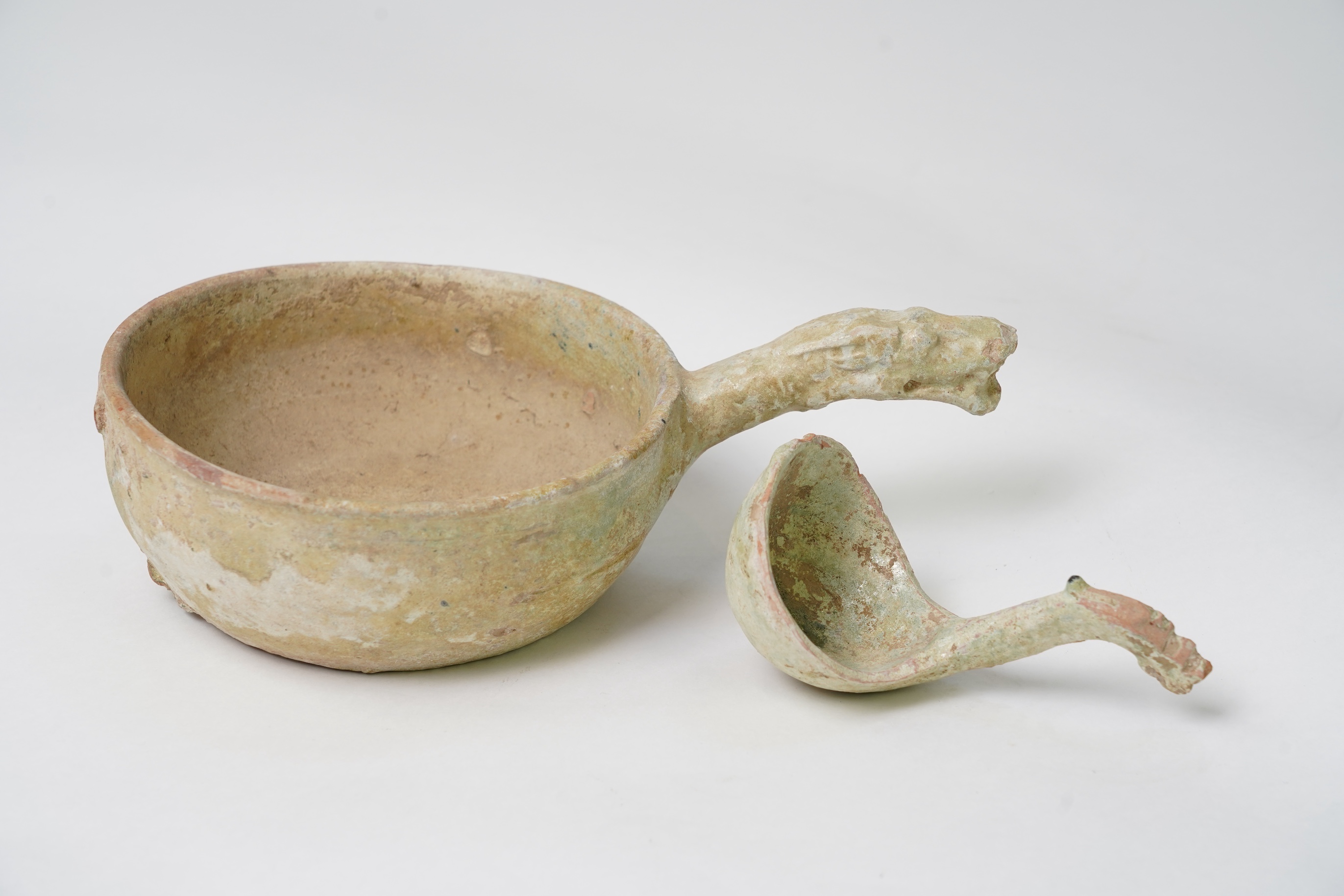 A Chinese earthenware scoop and a similar ladle, Han Dynasty (1st-2nd century A.D.)